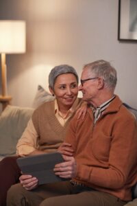 senior couple sitting on couch at home