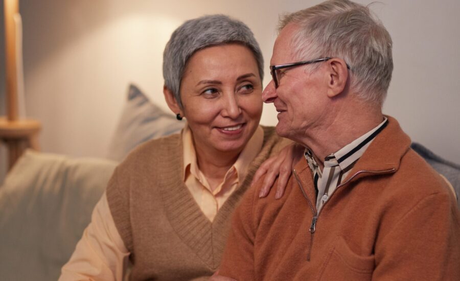 senior couple sitting on couch at home