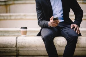 man reading smartphone on coffee break