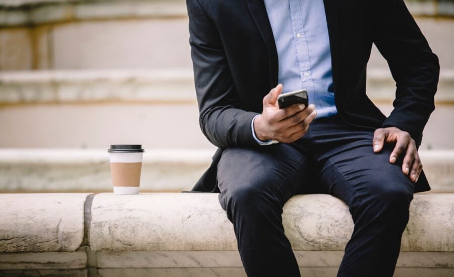 man reading smartphone on coffee break