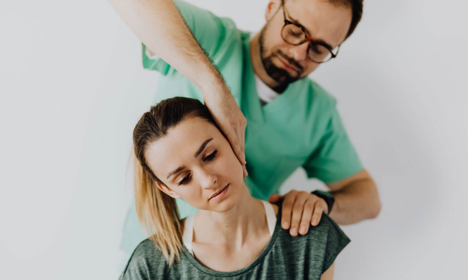 A woman having her neck treated by a rehabilitation specialist.
