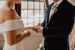 couple getting married by window