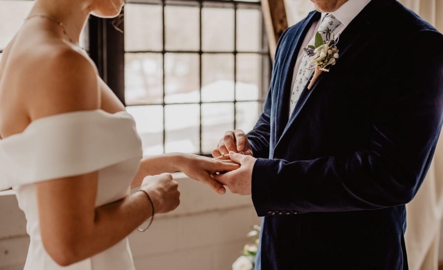 couple getting married by window