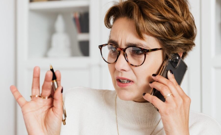 woman on phone with a concerned expression