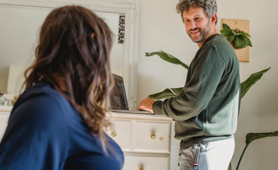 man and woman looking at each other in their home