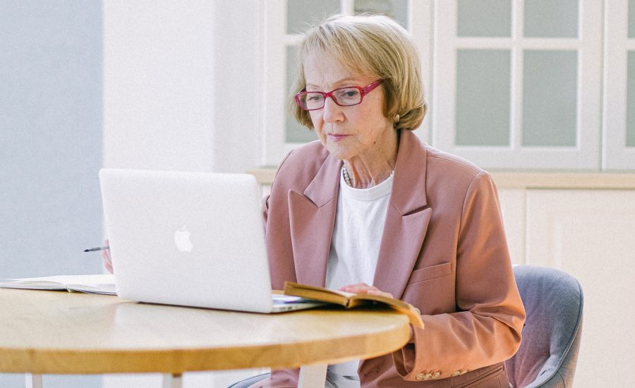 senior woman using laptop computer at table