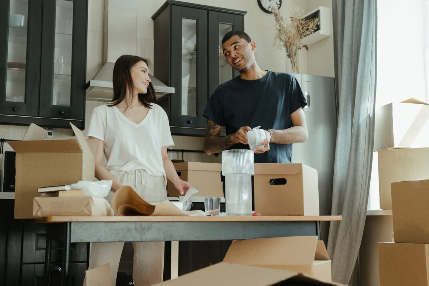 woman and man packing boxes for move