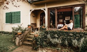 A woman reading in the window of her new home–happy as can be.