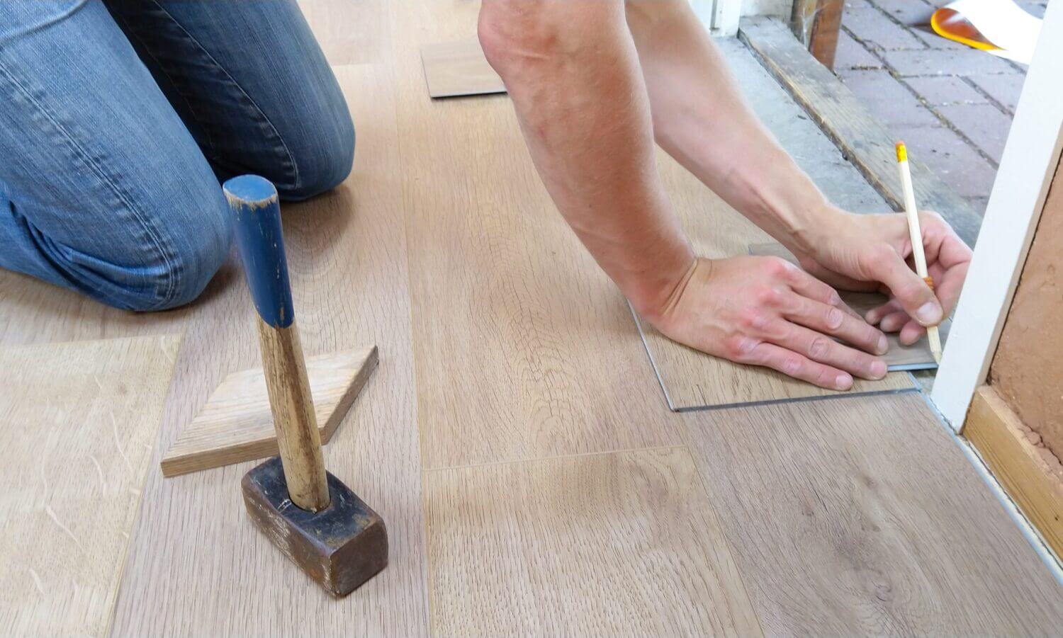 person installing flooring inside a home
