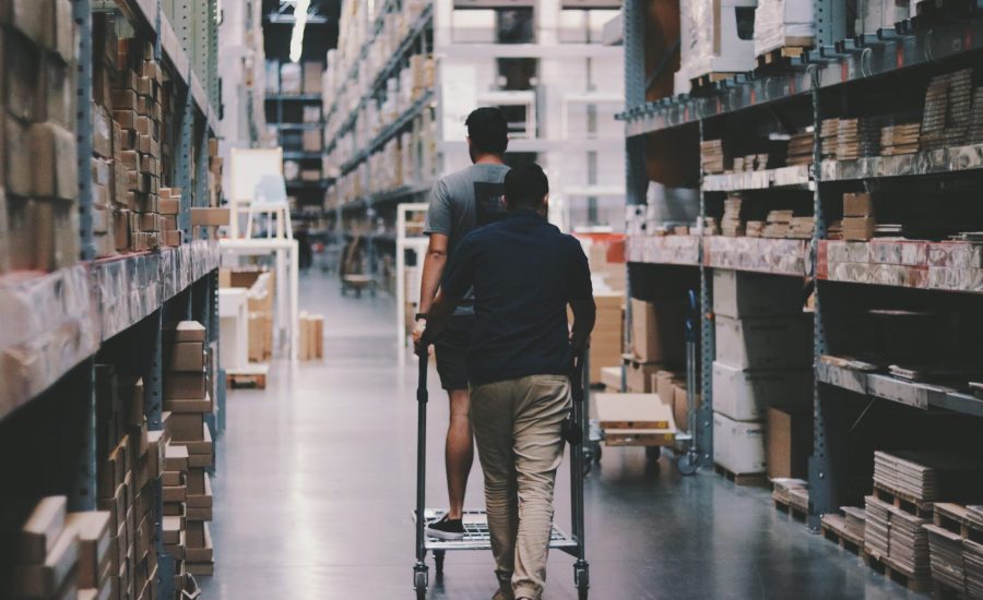 two men with a cart in warehouse