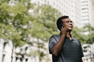 older man speaking on mobile phone