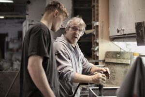 Older man and younger man working on home repairs