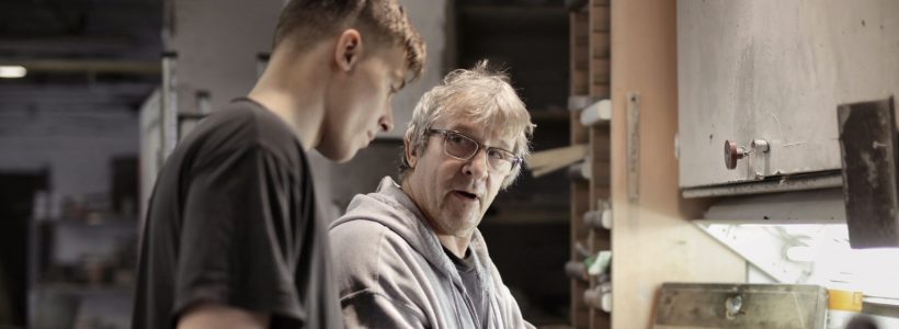 Older man and younger man working on home repairs