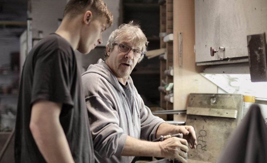 Older man and younger man working on home repairs