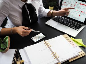 real estate agent looking at floor plans on laptop