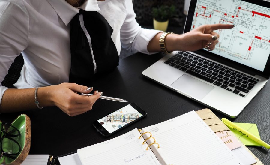 real estate agent looking at floor plans on laptop