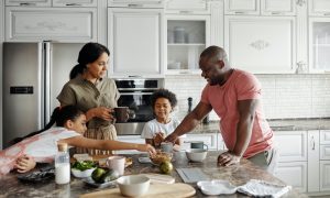 Family eating granola together in their top-of-the-line kitchen