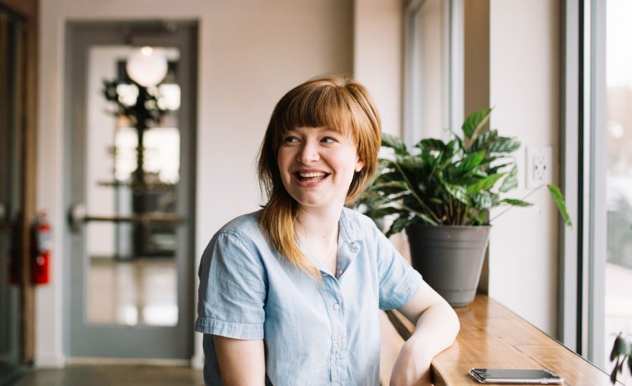 A smiling woman at a coffee bar.