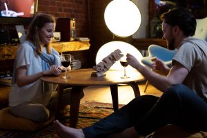 couple at home playing Jenga and drinking wine