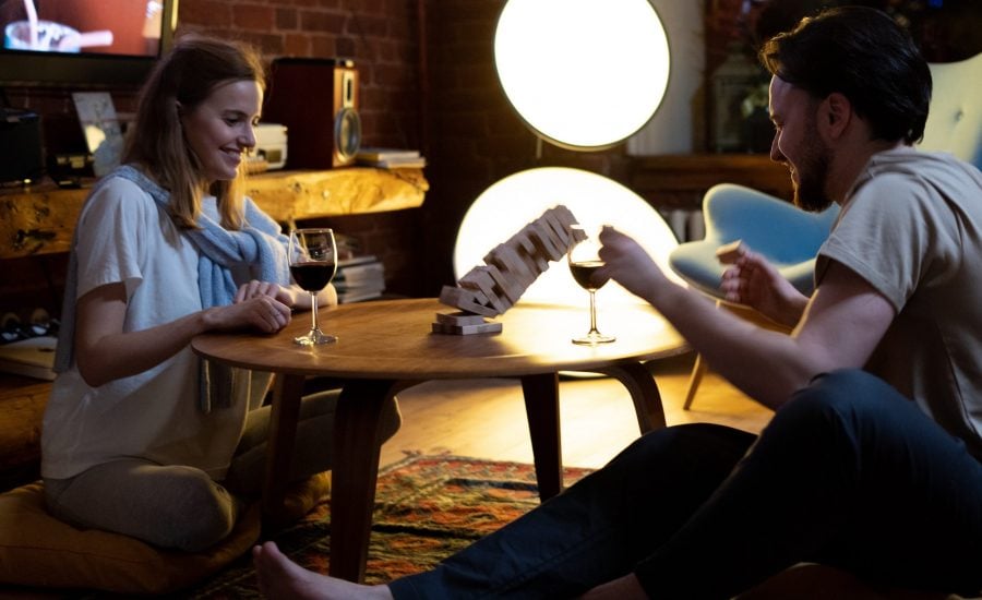 couple at home playing Jenga and drinking wine