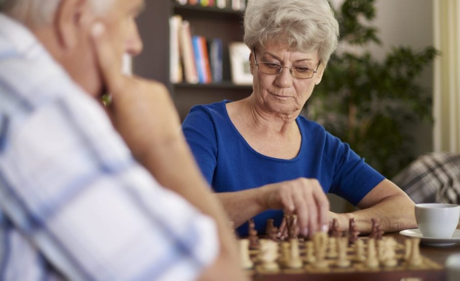 silver-haired couple playing chess