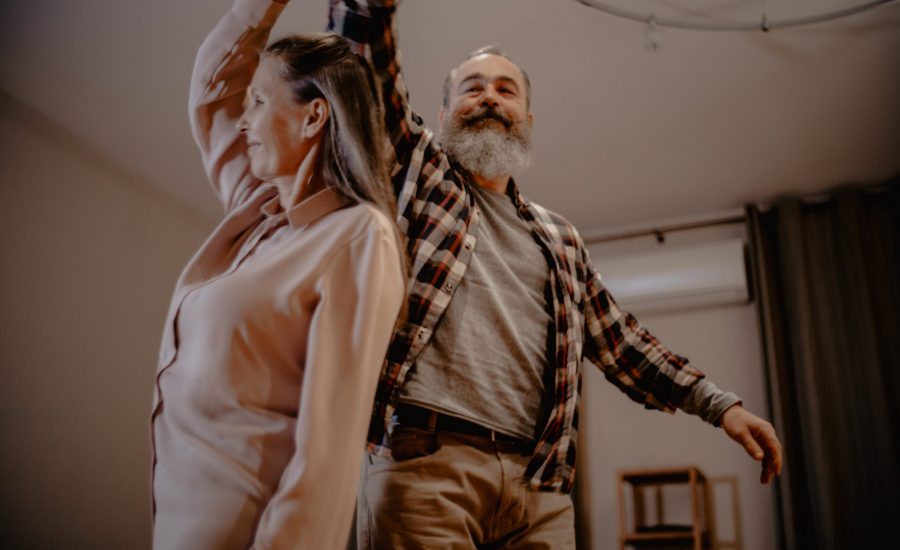 older couple dancing in their living room