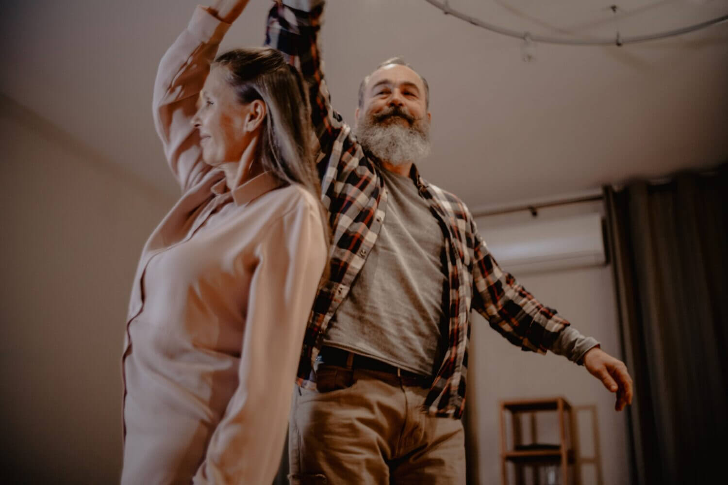older couple dancing in their living room