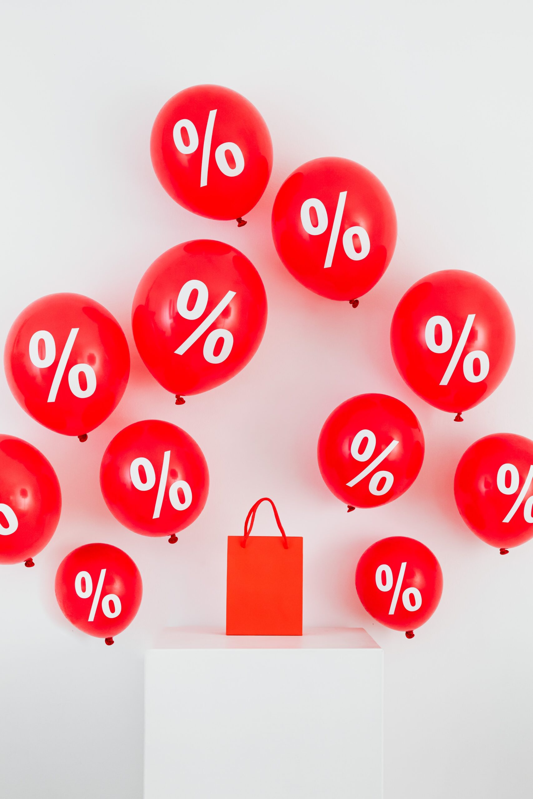 red balloons printed with percentage signs