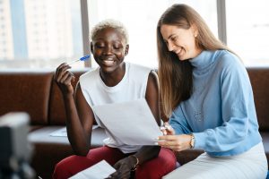 two women signing restrictive covenant in office