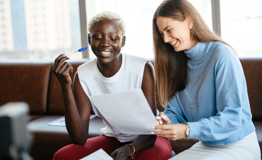 two women signing restrictive covenant in office