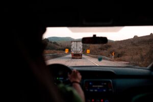 car driver behind a truck on highway