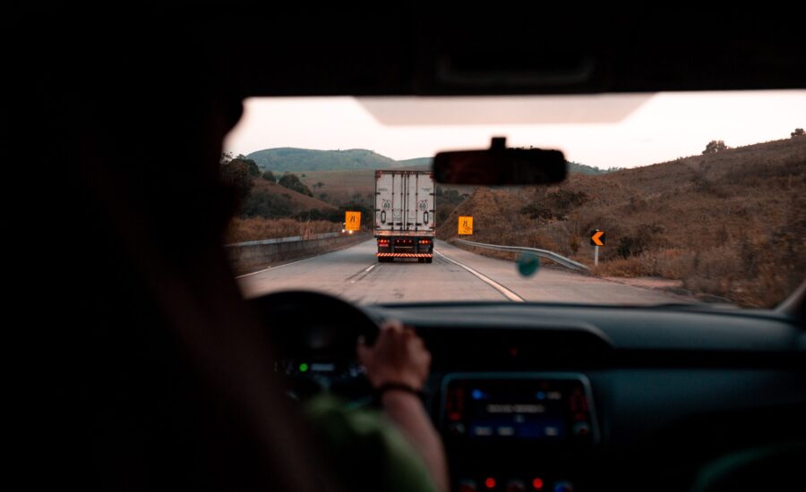 car driver behind a truck on highway