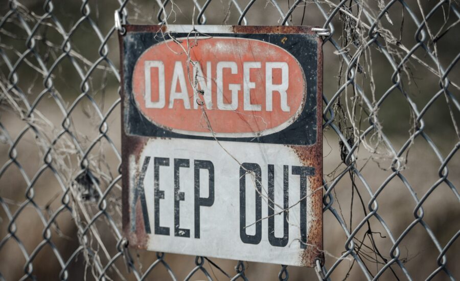 danger sign on chain-link fence