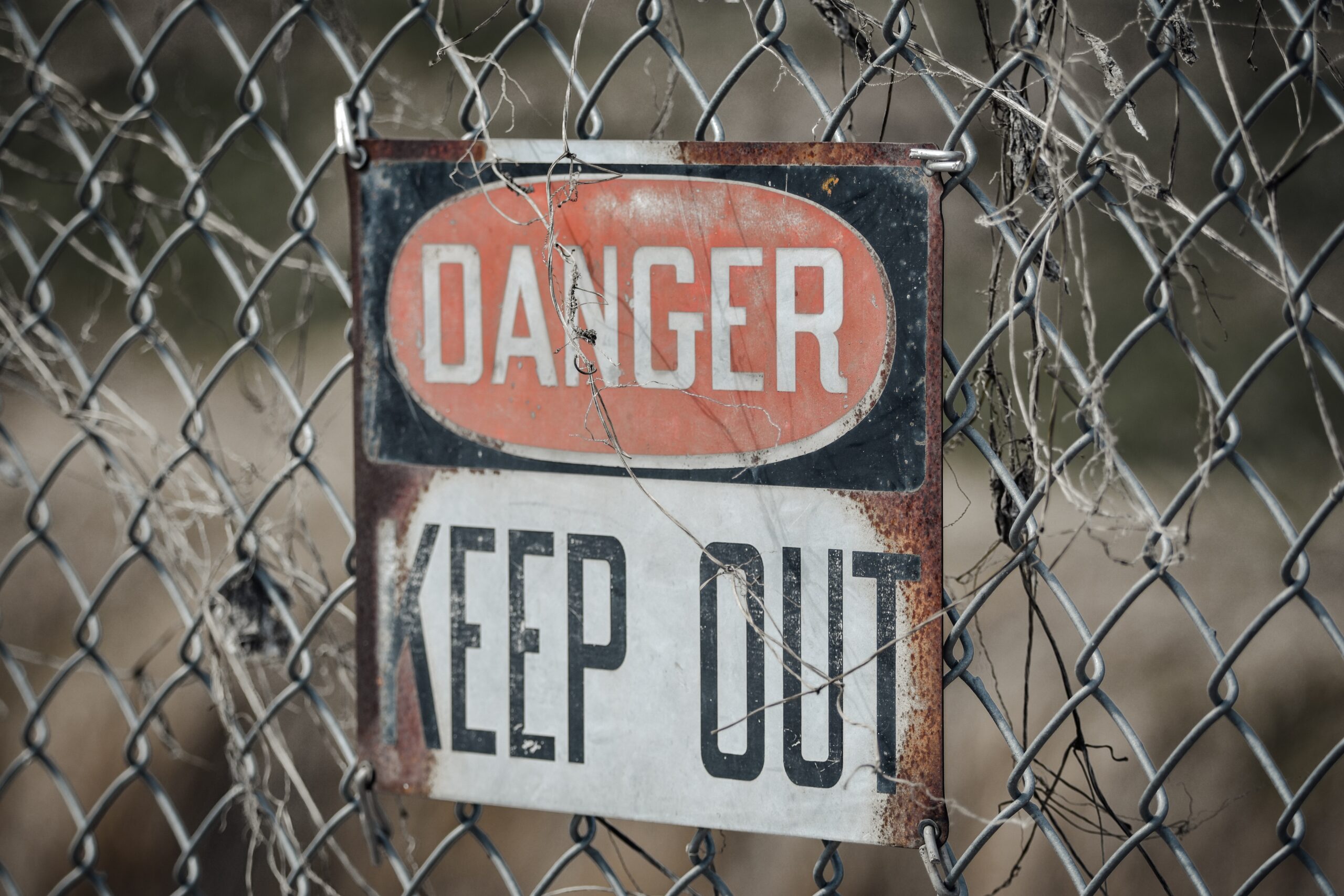 danger sign on chain-link fence