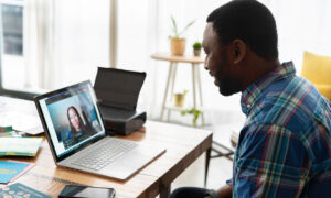 man on video call with coworker