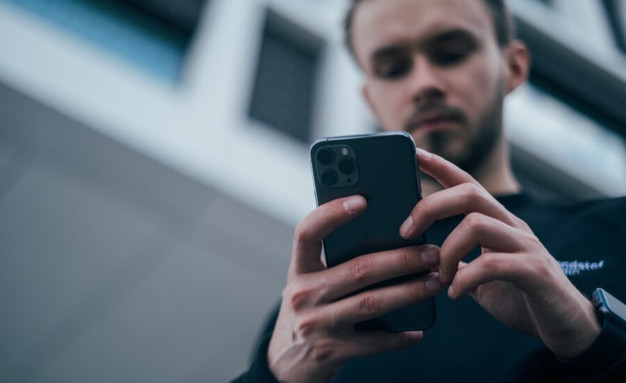 Man looking at phone for how to buy cardano in Canada