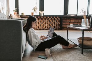 young woman sitting on floor of apartment