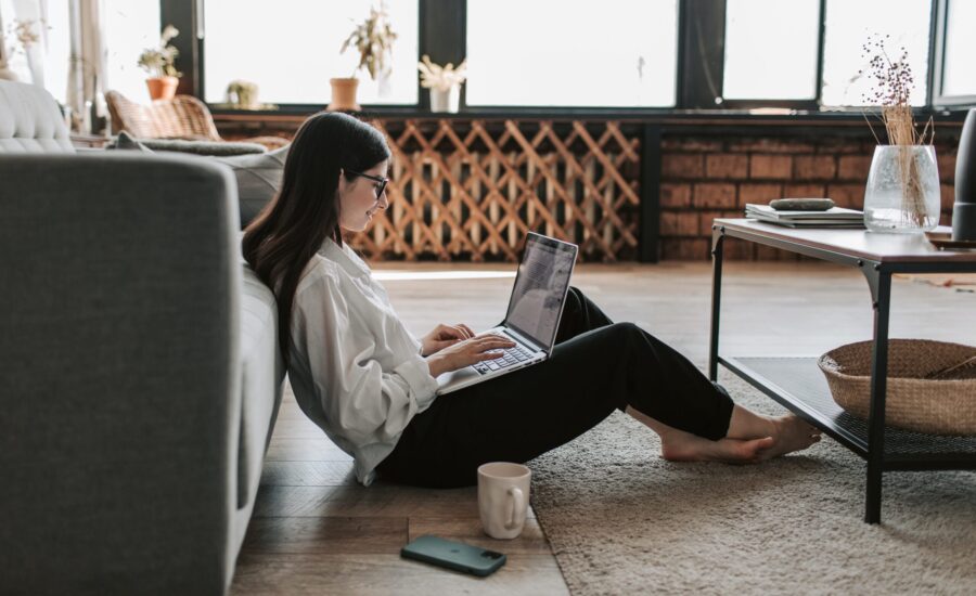 young woman sitting on floor of apartment