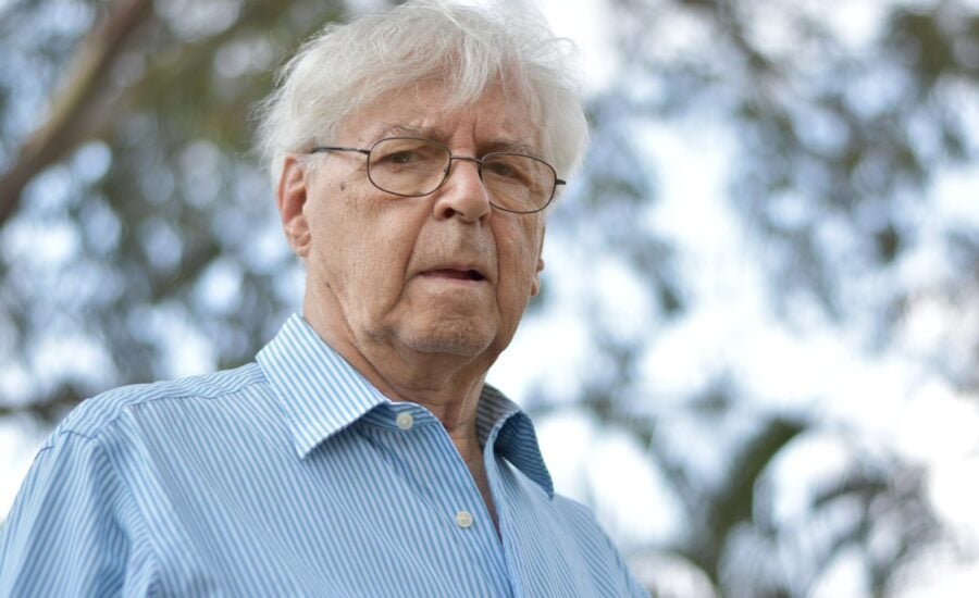 white-haired man standing outdoors