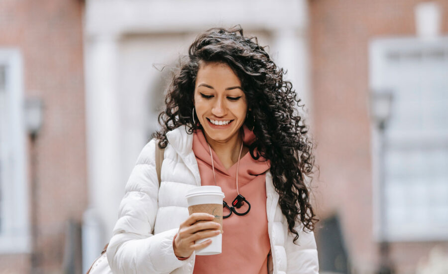 A photo of a smiling woman who just paid for a coffee