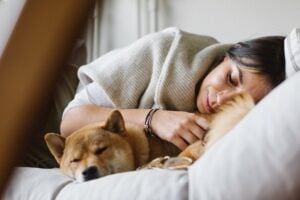 woman napping with dog