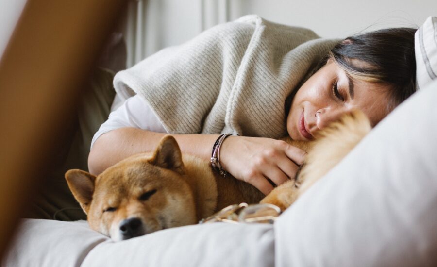 woman napping with dog