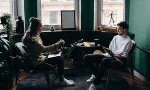 A couple in a living room, lively chatting about home ownership