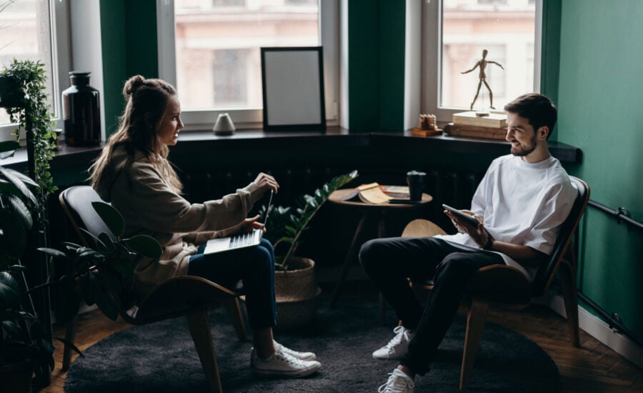 A couple in a living room, lively chatting about home ownership