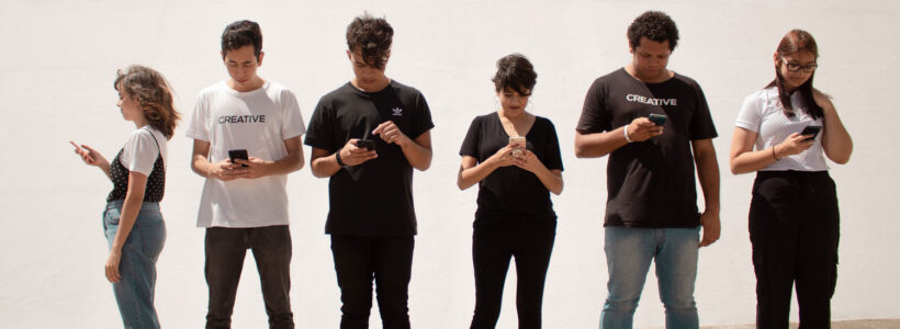 A group of teenagers all on their cellphones, checking their investments, we hope.