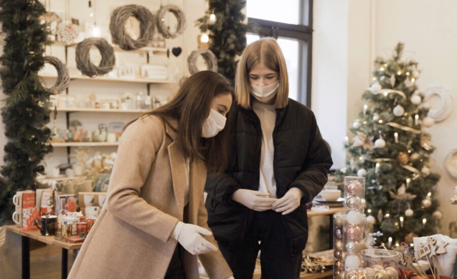 Two woman are seen looking at items in a store