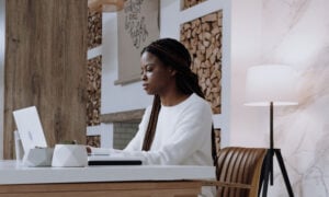 A woman using the MoneySense Finder tool at her work-from-home desk