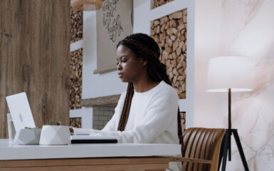 A woman using the MoneySense Finder tool at her work-from-home desk