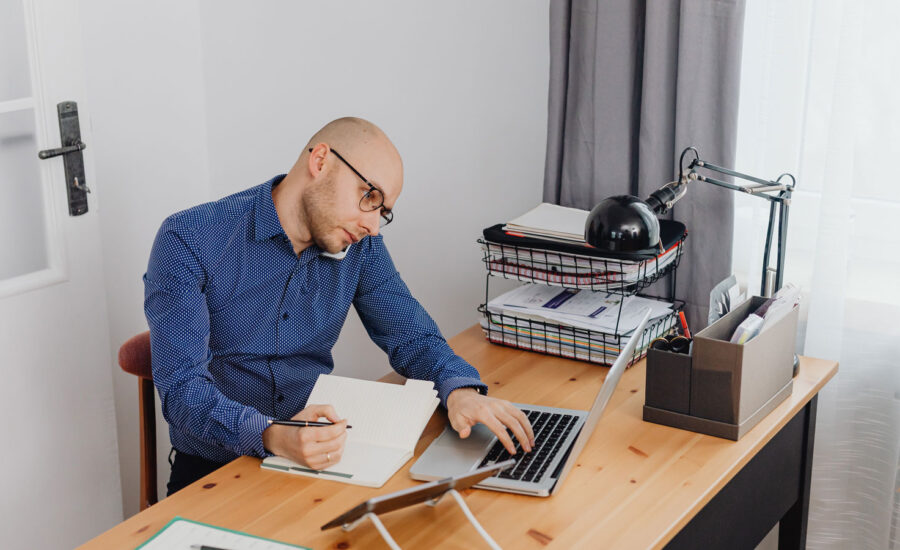 A man on a call, while sitting at his computer, trying to figure out if he should move his CPP into his RRSPs.