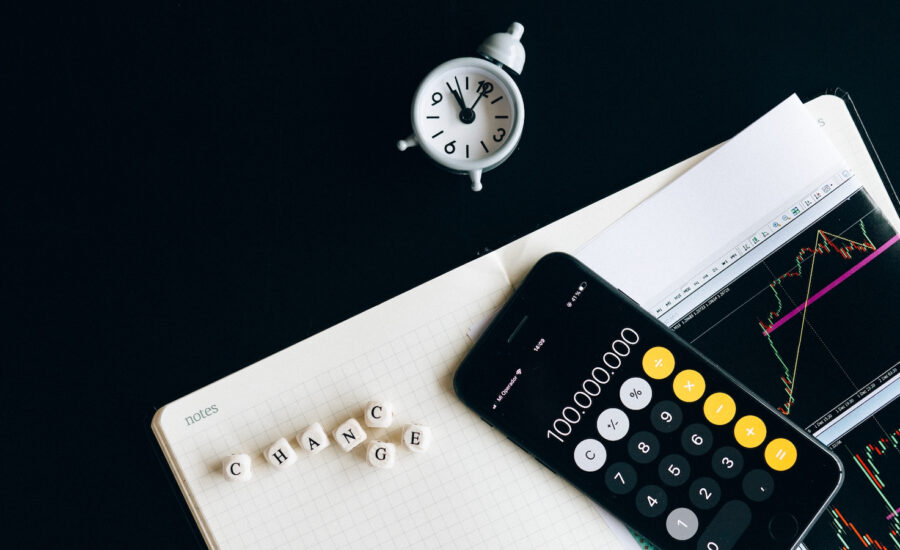 A image of phone and dice spelling change is seen spread across a table